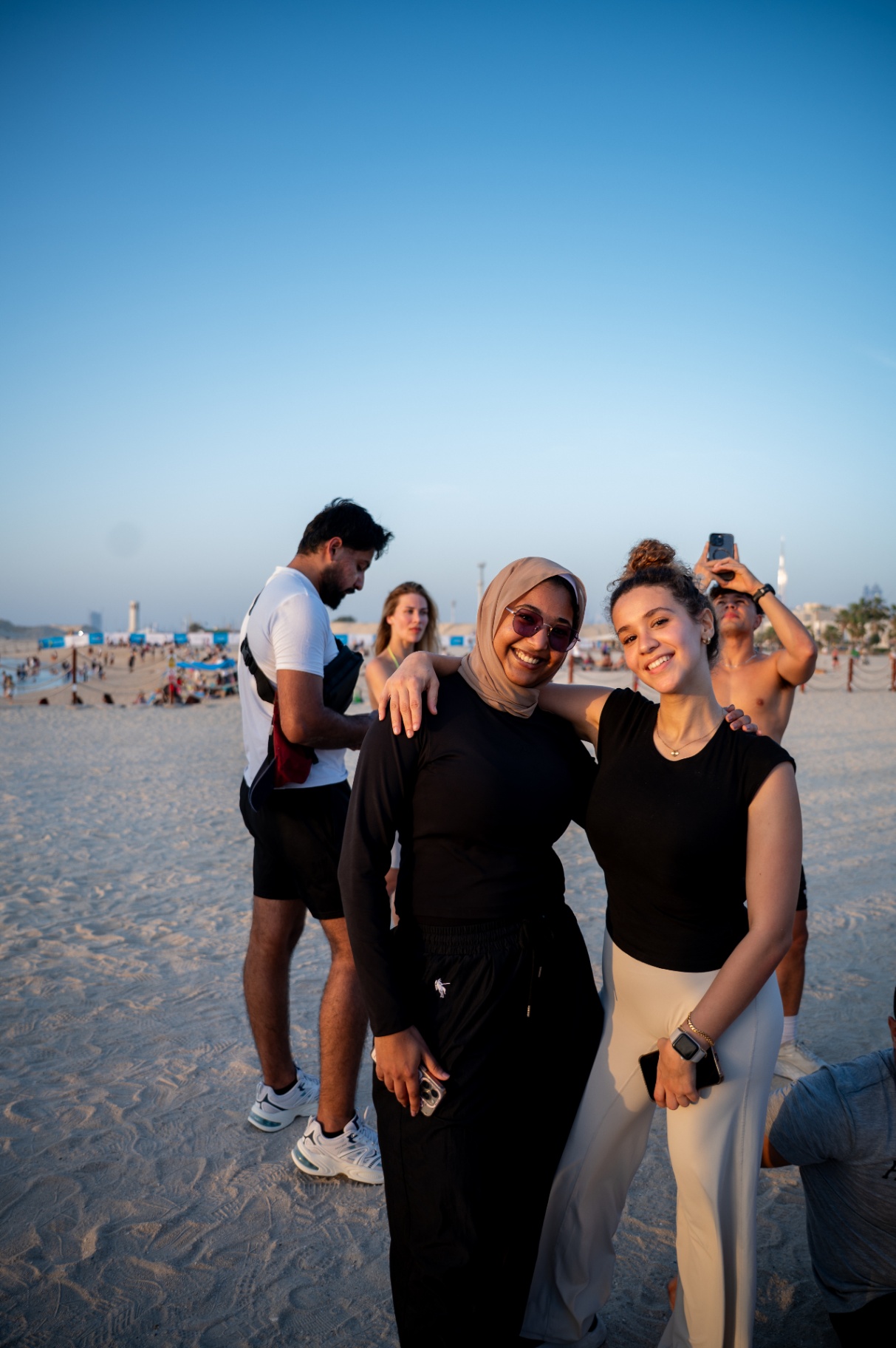 Friends smiling at sunset